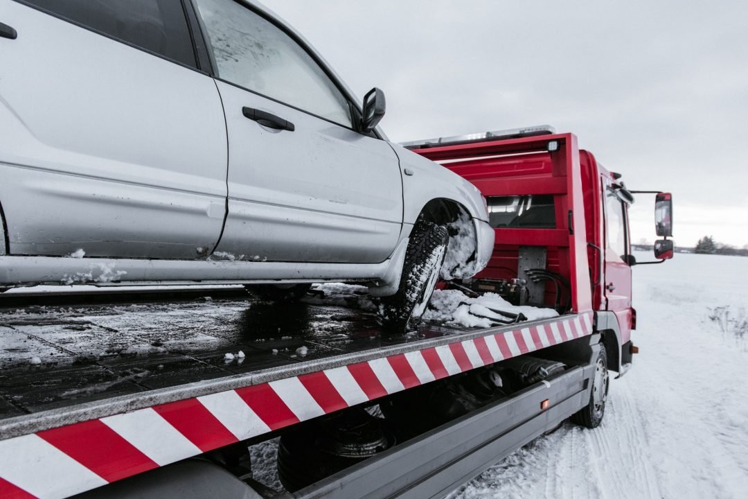 Recovered car on a tow truck in tough conditions