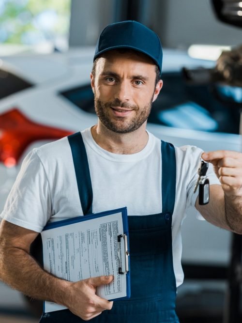 Sydney Towing team member holding car keys and a job clipboard