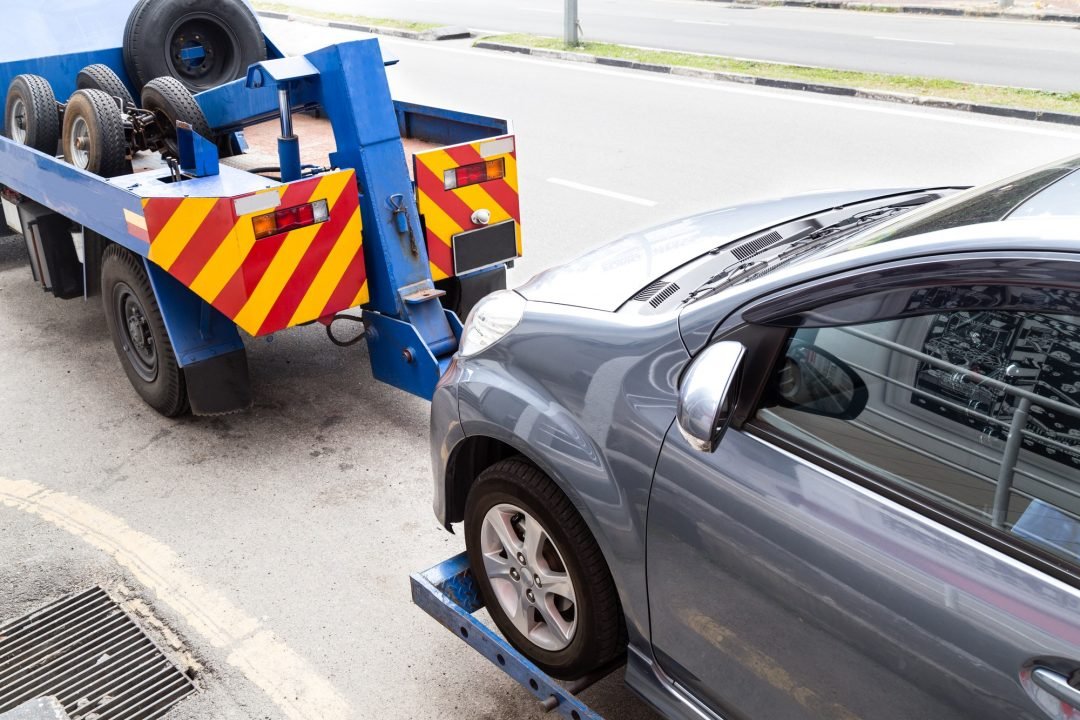 Tow truck towing a broken down car